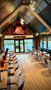 a large room with tables and chairs and a fireplace at Siberia Bar & Hotel in Aberdeen