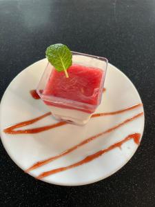 a drink on a white plate with sauce at Wellness hotel Velky Meder in Veľký Meder