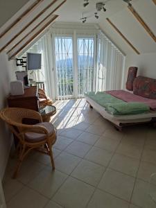 a bedroom with a bed and a desk and a chair at Johannesburg in Révfülöp +79 photos
