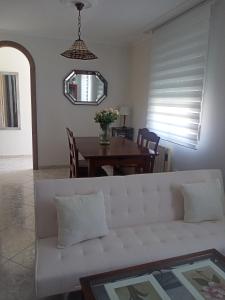 a living room with a white couch and a table at Casa de Concha in Burela de Cabo
