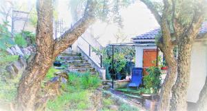 a house with stairs and a blue chair next to a house at Au Jardin Des Couleurs in Pierrefeu-du-Var +15 photos