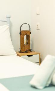 a bed and a table with a bag on it at Kali Strata 1 - Downtown in Symi