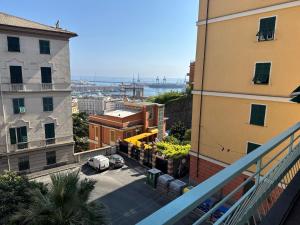 a view from a balcony of a city with buildings at KALEIDO Hostel in Genoa
