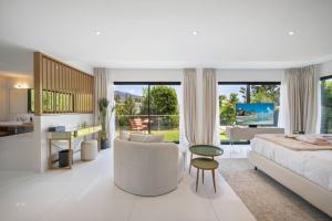 a large white bedroom with a bed and a desk at Villa Romy, a World apart in Roquebrune-Cap-Martin +80 photos