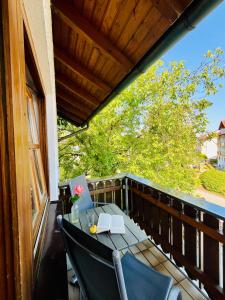 a balcony with a table with a laptop on it at Gästehaus Huber - Hotel Garni in Bad Füssing