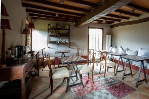 a living room with tables and chairs in a room at Borgo Vercallo in Case la Selva