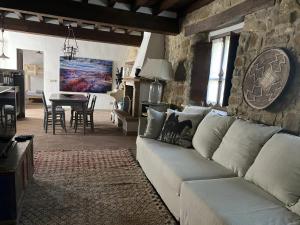 a living room with a white couch and a table at Borgo Vercallo in Case la Selva