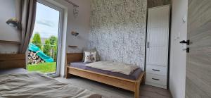 a small bedroom with a bed and a window at Gartenbungalow Rhönherz in Hilders