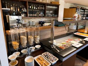 a buffet line with pastries and other food items at Burggasthof Weißenstein in Regen