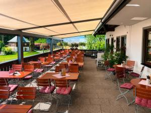 a row of tables and chairs on a patio at Burggasthof Weißenstein in Regen