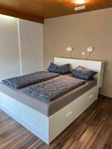 two beds in a bedroom with two lamps on them at promedklinik apartment 4 in Volkach