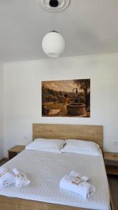 a bedroom with a bed with two towels on it at Villa Kroi i Vashes in Peqin +54 photos