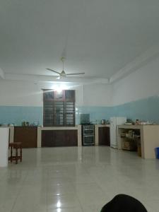 a large kitchen with a ceiling fan in a room at Kwetu nungwi in Kinyasini
