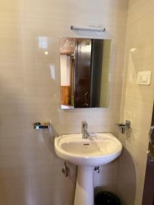 a bathroom with a sink and a mirror at Lecoxy Resort in Lachung +9 photos