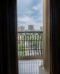 a view of a city from a window of a building at Hamsun Apart Hotel Clifton in Karachi