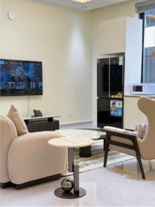 a living room with a couch and a table at Zabibu Residence in Nkongontha