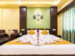 a hotel room with a bed with two people made out of towels at Hotel Surya Resort in Sonepur