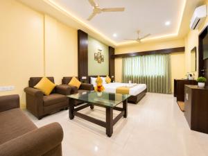 a hotel room with a bed and a table at Hotel Surya Resort in Sonepur