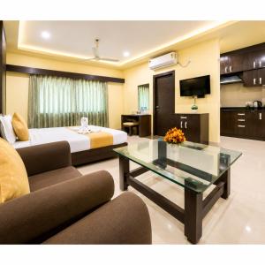 a hotel room with a bed and a coffee table at Hotel Surya Resort in Sonepur