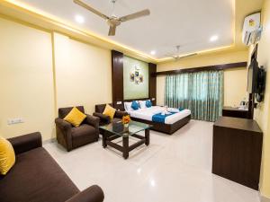 a living room with a bed and a couch at Hotel Surya Resort in Sonepur