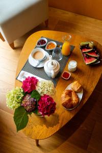 a table with breakfast foods and flowers on it at Hotel Jaizkibel in Hondarribia