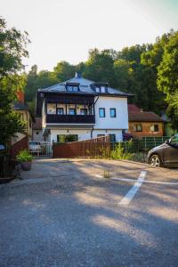 a large white house with a fence in front of it at Riverside Residence Apartment in Travnik +2 photos