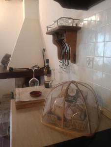 a kitchen counter with a glass dish rack on it at Borgosulnera - Oltre il tempo in Ferentillo