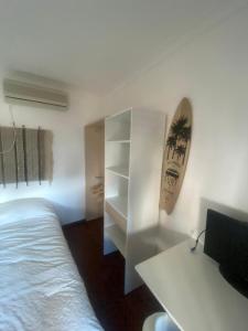 a bedroom with a white bed and a desk at Pinzalez  +8 photos