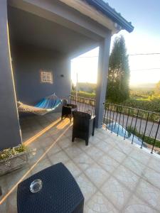a patio with a hammock and a balcony with a view at Pinzalez 