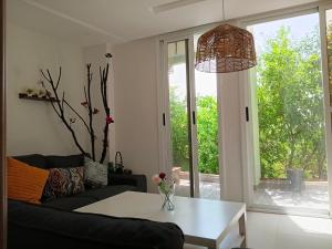 a living room with a couch and a table at Le Jardin Aparthotel in Taza