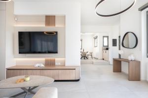 a living room with a tv on a wall at Sofia's Estates - Villa Athena -Adults Only- in Kos +52 photos