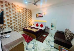 a bedroom with a bed and a couch in a room at Solan Regency in Solan