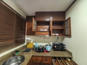 a kitchen counter with a sink and a microwave at Langkawi Lagoon Floating Resort 03 in Kampung Padang Masirat