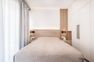 a bedroom with a bed and a white cabinet at Sofia's Estates - Villa Athena -Adults Only- in Kos