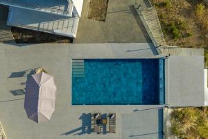 an overhead view of a swimming pool with an umbrella at Sofia's Estates - Villa Athena -Adults Only- in Kos