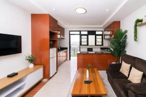 a living room with a couch and a table at Highlands Suites Hotel and Apartments in Kigali