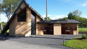 a small house with a black roof at Tente lodge in Brassac