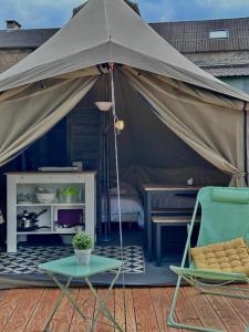 a tent with a chair and a table and a chair sidx sidx sidx at Tente lodge in Brassac