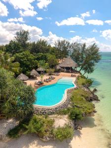 an aerial view of a resort swimming pool and the ocean at Pongwe Beach Hotel in Pongwe +36 photos