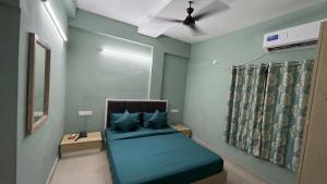 a bedroom with a bed and a ceiling fan at FabHotel Metro Stay in Kolkata
