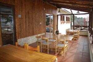 a dining room with wooden tables and chairs at Guest House Caracas in Lorica