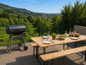 a picnic table with a grill and wine glasses at Casas Mesão Frio by Guestify in Guimarães