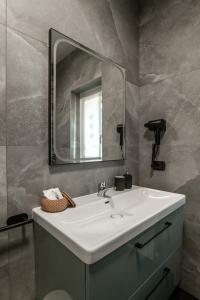 a bathroom with a white sink and a mirror at Lario Panorama in Colico +36 photos
