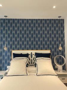 a bedroom with a large bed with a blue wall at Apartamento Costa II con Parking exterior comunitario in Zumaia +23 photos