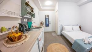 a kitchen with a sink and a bed in a room at Kali Strata 1 - Downtown in Symi +16 photos