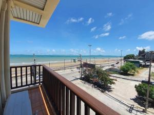 a balcony with a view of the beach at Sarita Chalet & Spa Jomtien beach Pattaya in Jomtien Beach