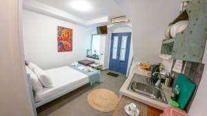 a bedroom with a bed and a sink in a room at Kali Strata 1 - Downtown in Symi