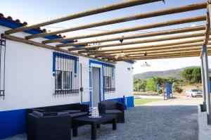 a pergola with couches and chairs on a patio at O Rossio in Esperança
