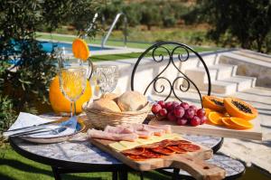 a table with a tray of cheese and fruit on it at O Rossio in Esperança