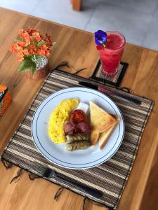 a plate of breakfast food on a table at ChannaS villas in Payangan